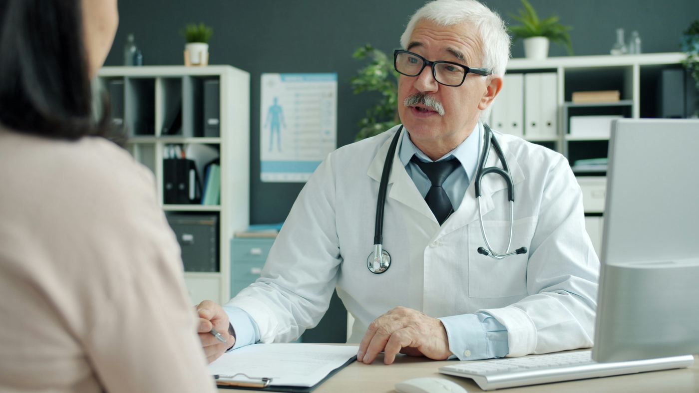 Doctor talking with a patient at a desk