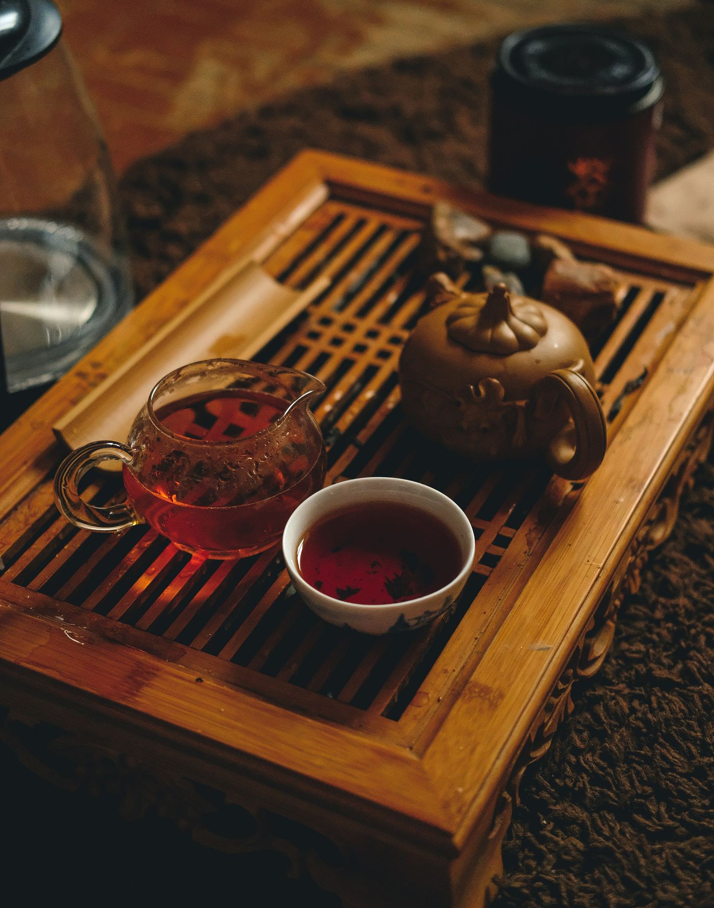 Cup of tea beside a clay teapot