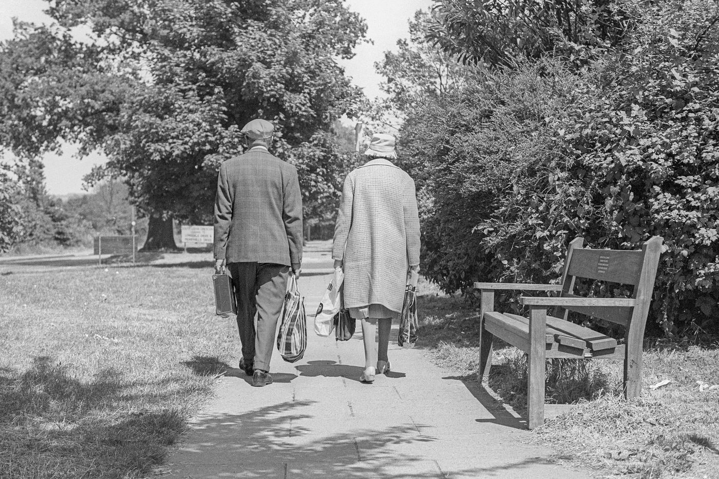 Older couple walking along a park path