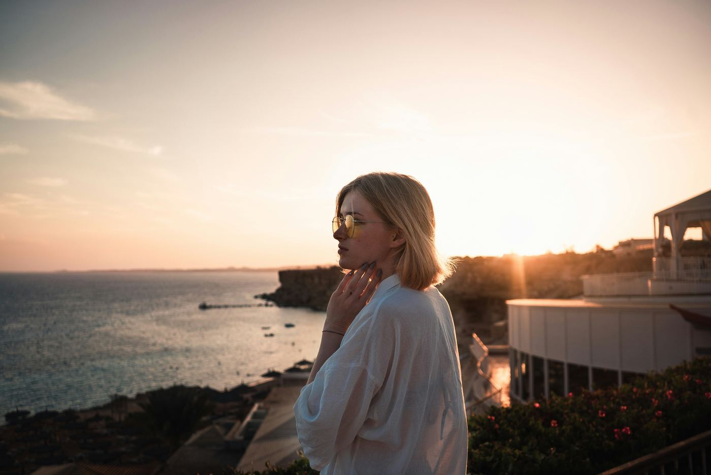 Woman at sunset touching her throat