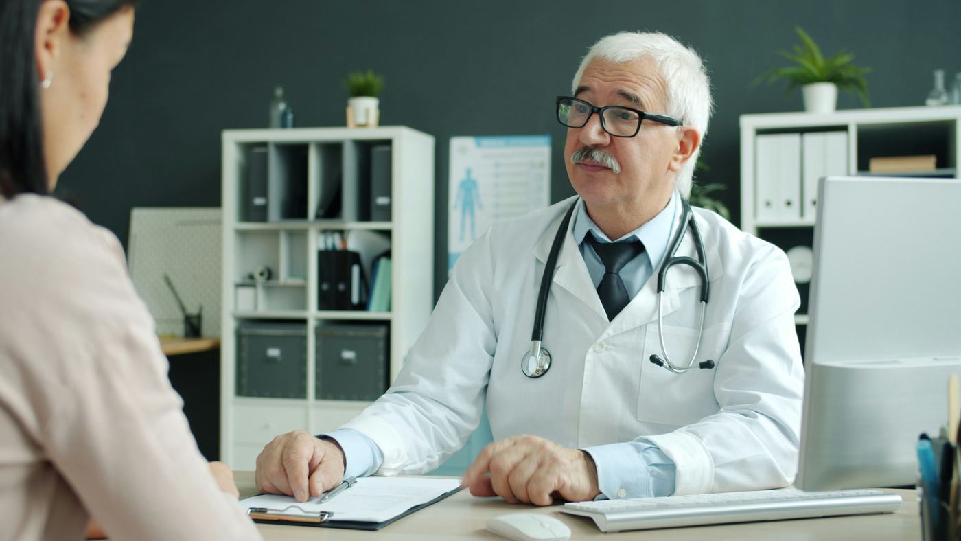Doctor listening to a patient in a consulting room